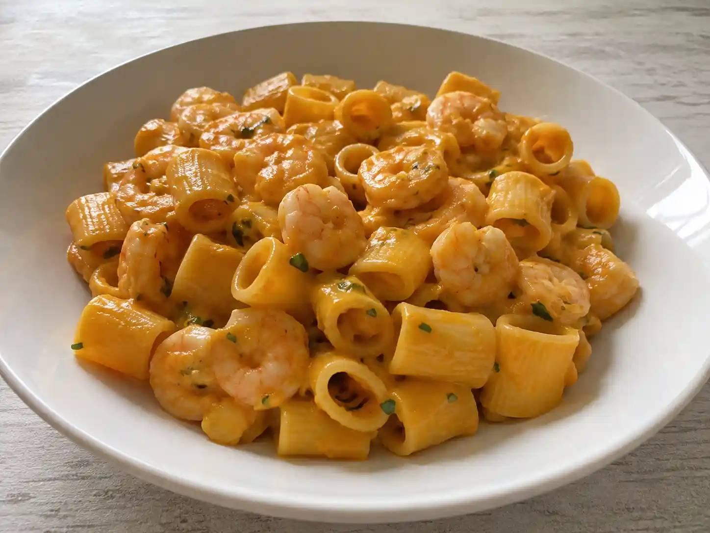 Pasta con zucca e gamberi cremosa con mezze maniche, crema arancione e gamberi teneri