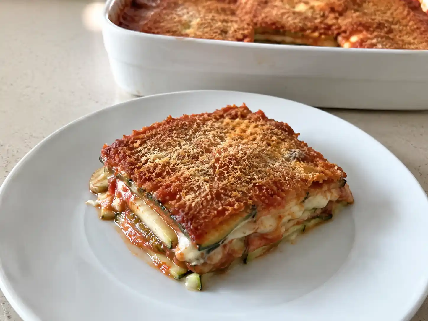 Lasagne di zucchine senza pasta al forno con pomodoro, scamorza filante e superficie gratinata