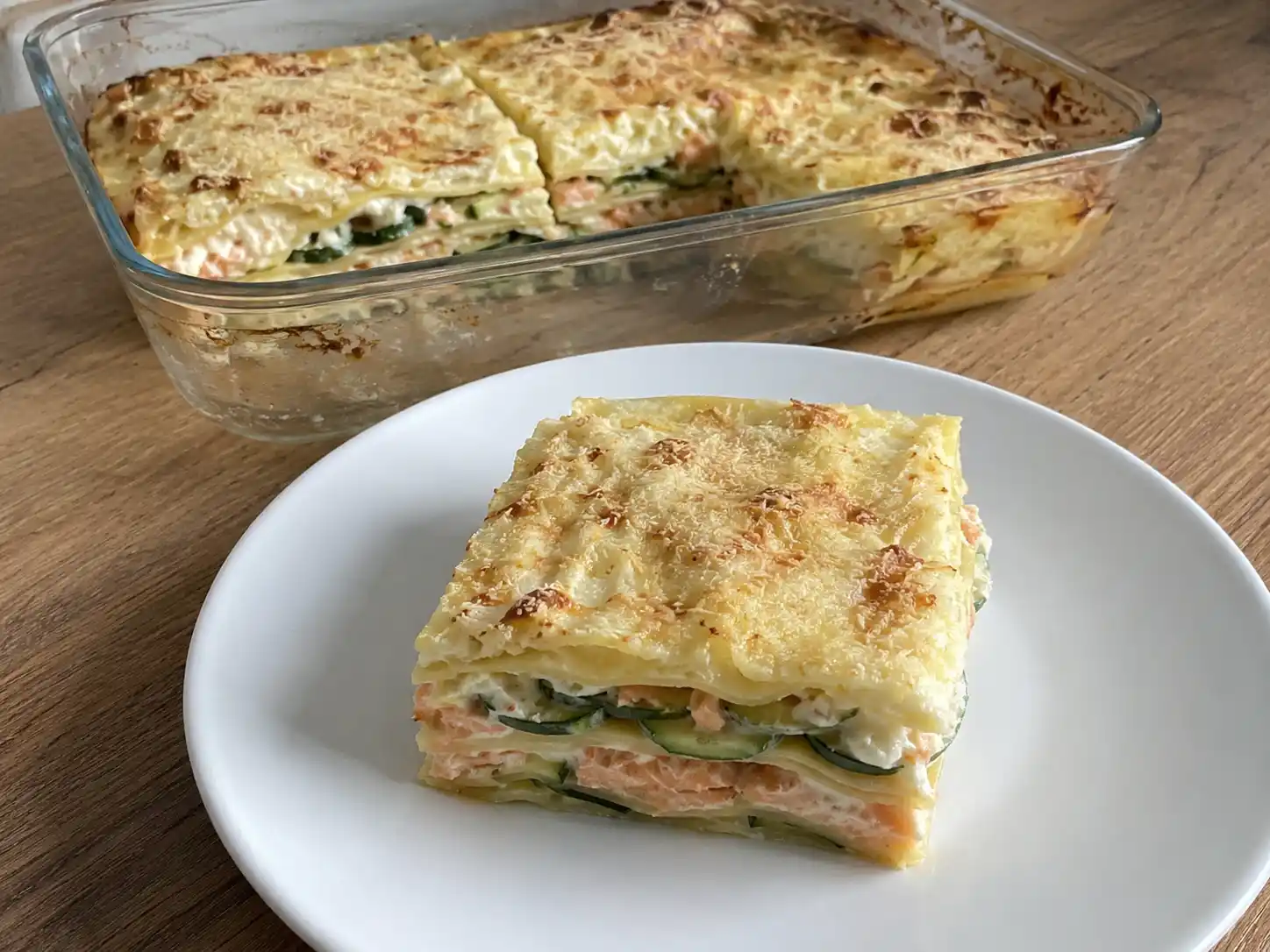 Lasagne salmone e zucchine al forno, cremose e dorate, servite a tranci morbidi